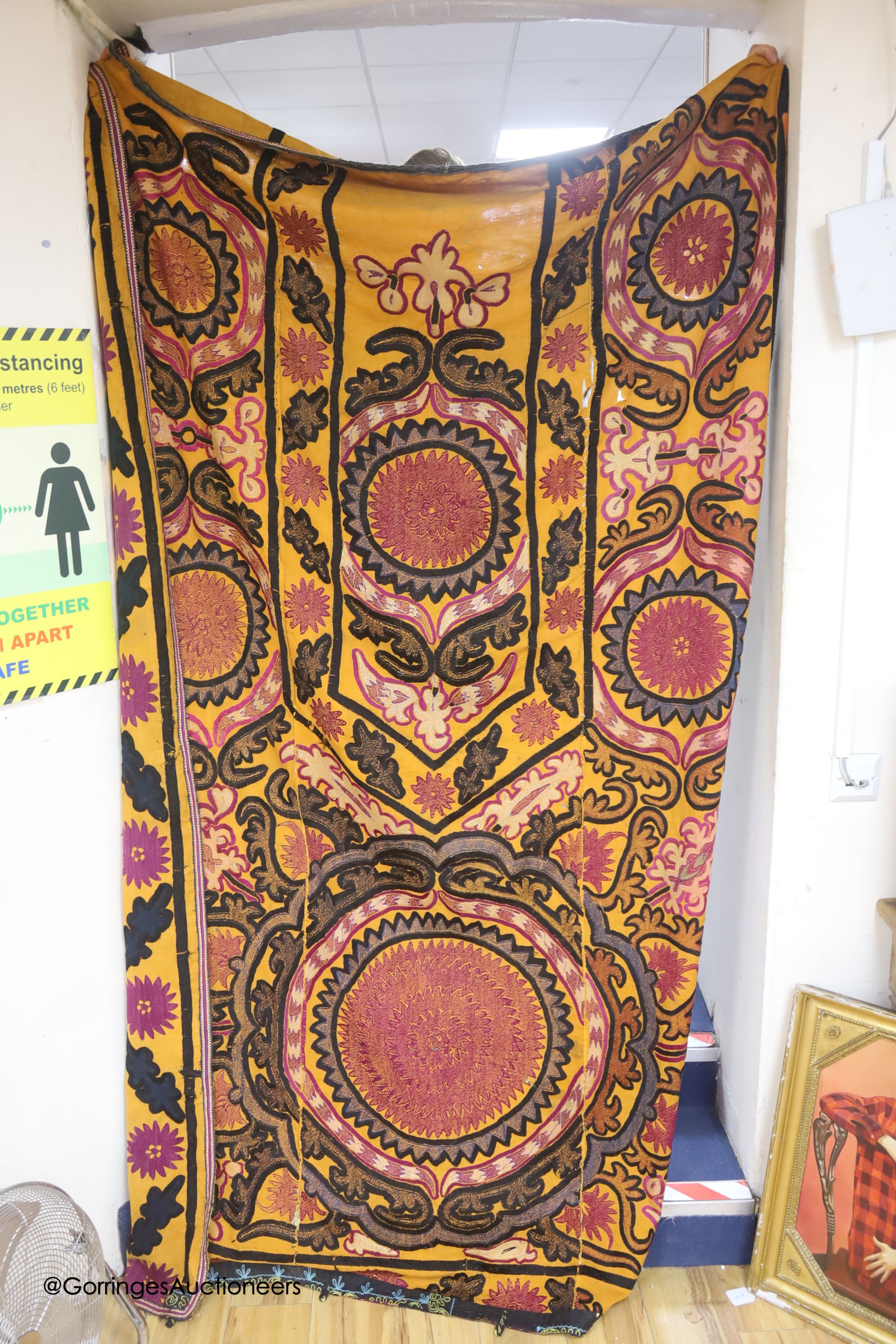 An orange ground Suzani prayer arch, circa mid to late 19th century, length 240cm width 166cm